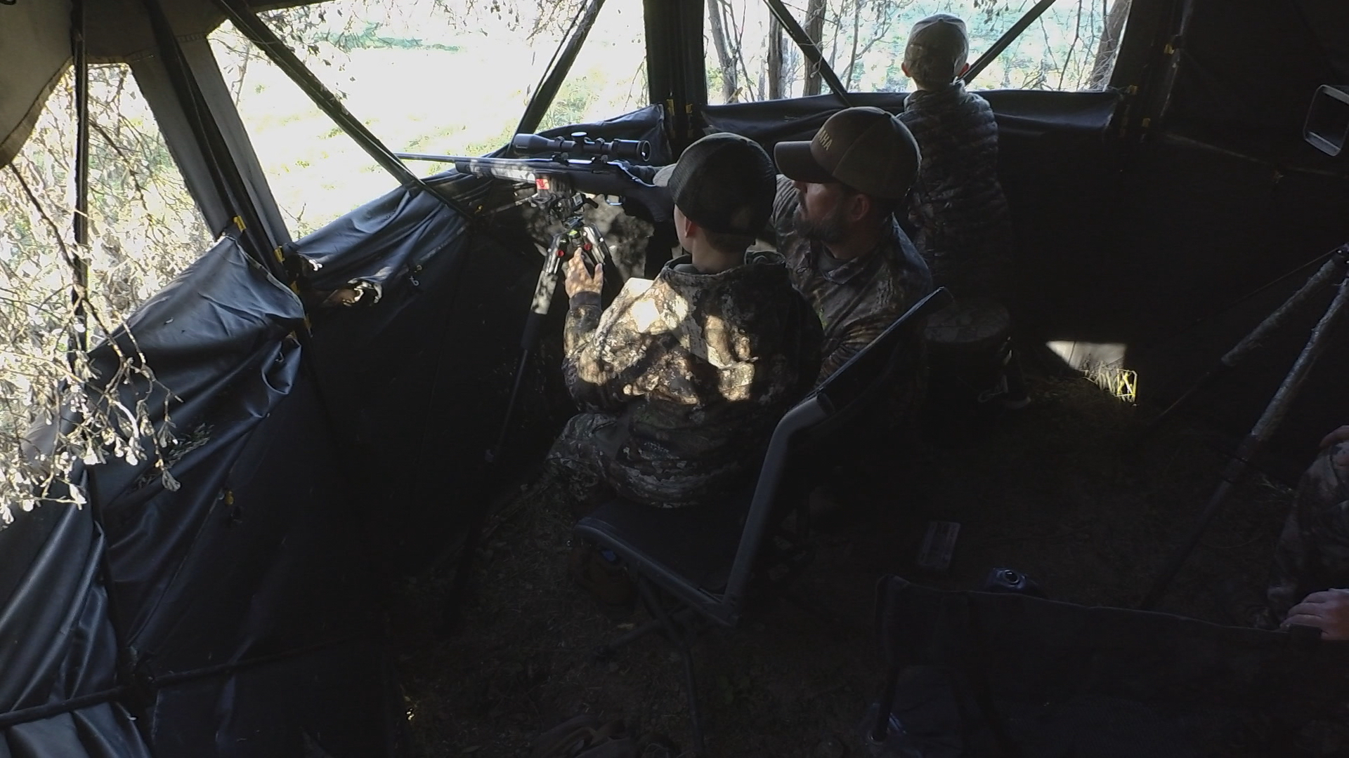 Landon (left) gets insturciton for his father Steve while Callen keeps an eye out for deer.