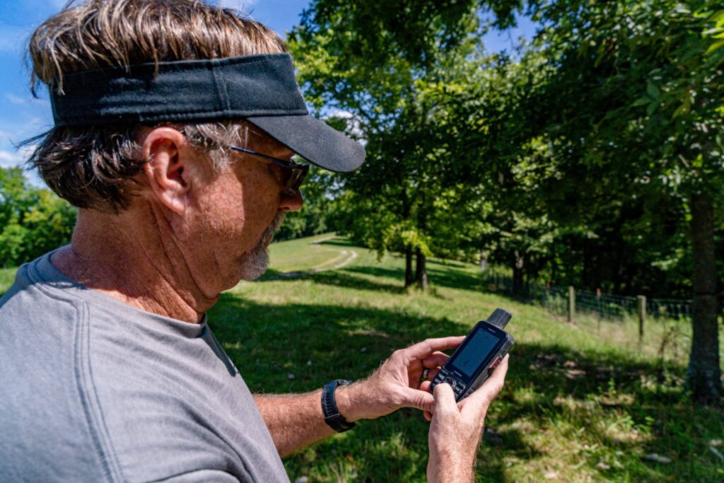 Man using his Garmin GPS for an out of state hunting trip.