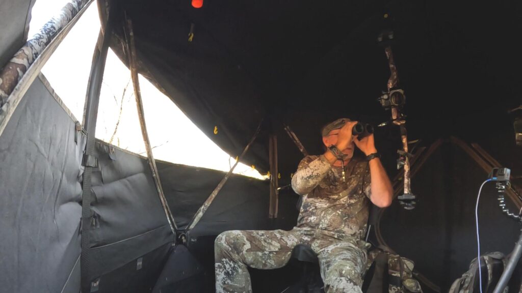 Hunter in ground blind during bow hunt